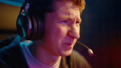 Young teen streamer gamer man play fail online video computer game. Esport concept virtual entertainment. Cyber e sport videogame tournament live stream. Neon light. Tense player loss competition. © Татьяна Епанешникова