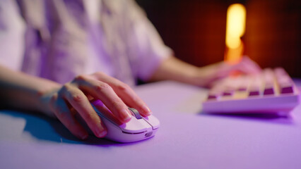 Gamer woman playing online video game computer closeup. Esport concept gaming virtual entertainment. Cyber e sport videogame tournament hands control mouse keyboard close up. Neon light. Player level. © Татьяна Епанешникова