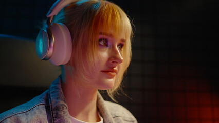 Young teen streamer gamer woman playing online video game on computer. Esport concept gaming virtual entertainment. E sport videogame tournament live stream. Tense female player cool girl competition. © Татьяна Епанешникова