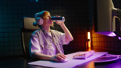 Young teen streamer gamer woman playing online video game on computer. Esport concept gaming virtual entertainment. E sport videogame tournament live stream. Tense female player cool girl competition. © Татьяна Епанешникова