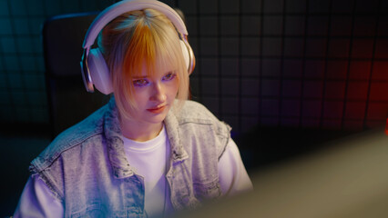Young teen streamer gamer woman playing online video game on computer. Esport concept gaming virtual entertainment. E sport videogame tournament live stream. Tense female player cool girl competition. © Татьяна Епанешникова