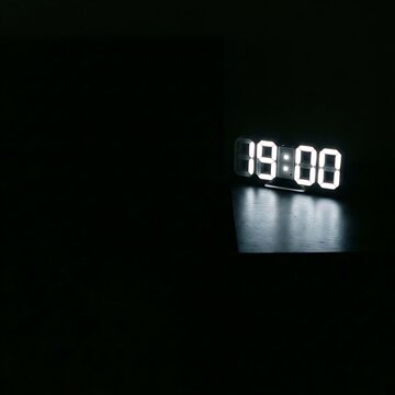 Digital Clock Displaying 19 -00 in Darkness.