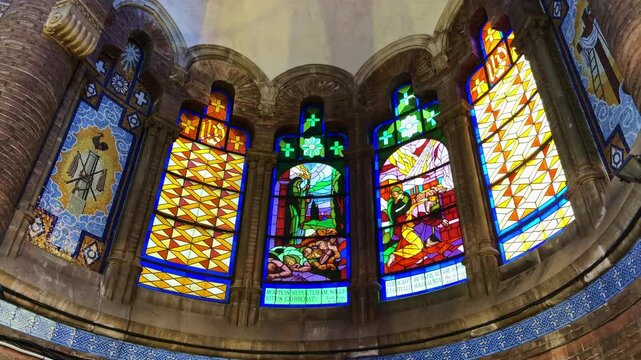 Interior detail of colorful art nouveau stained glass windows in a historic church of Hospital de Sant Pau in Barcelona, Spain. Low-angle pov
