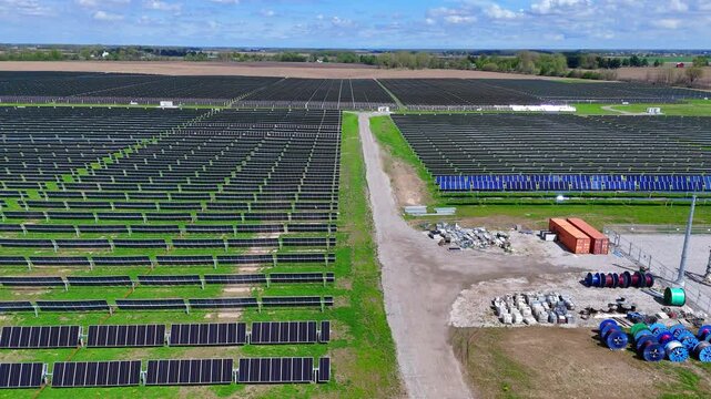 Blue Elk Solar Field generating renewable power in Adrian, Michigan, USA, rows of solar panels on field under sunny sky in Michigan