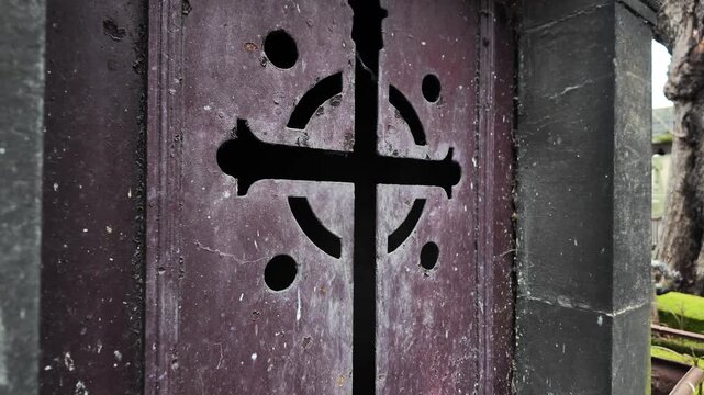 Ornate Mausoleum Crypt Door With Cross Symbol In Paris Cemetery France Featuring Weathered Metal And Stone Architecture For Historical Or Religious Themes