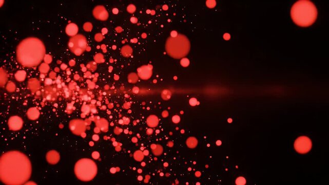 Red bokeh effect on black background.  Floating particles create depth and dynamism