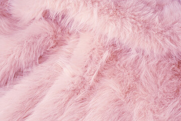 Elegant luxurious pastel pink faux fur surface textile material background offering a gentle cozy feeling
