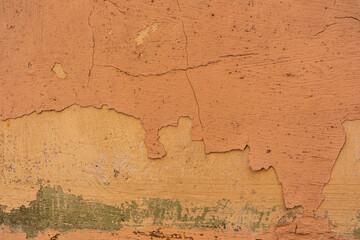 Obraz premium Peeling paint wall with orange for rustic building and aged surface concept