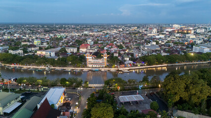 Obraz premium Aerial view of Banjarmasin showing city layout, buildings, and the 0KM monument along the riverbank