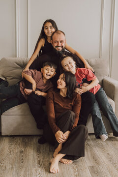 Happy family relaxing together at home hugging on the couch
