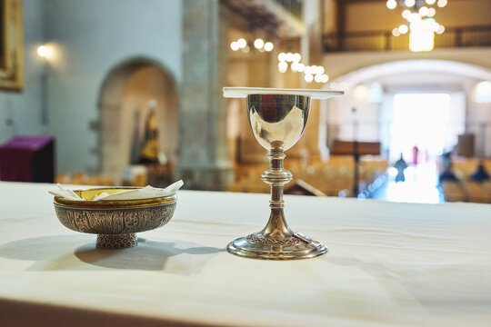 Chalice and paten on altar table inside church