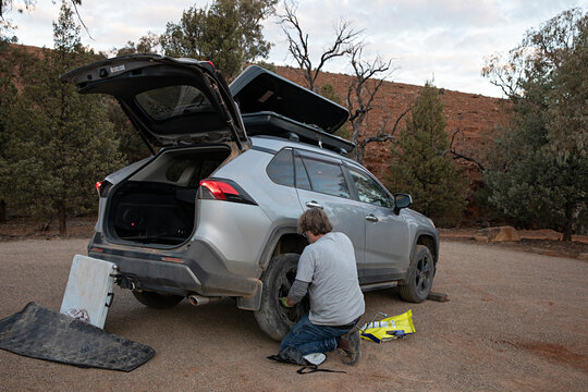 Man changing a punctured tyre over in the outback of Australia