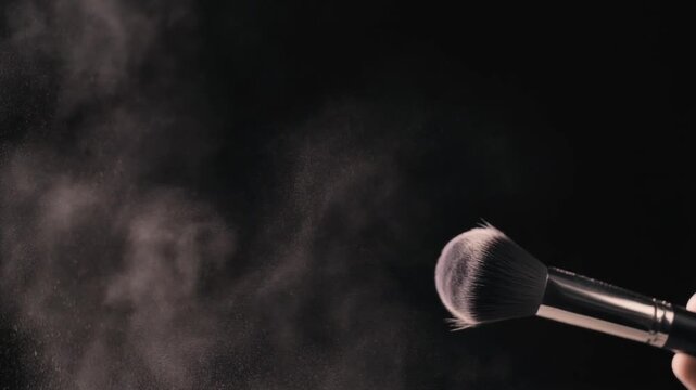 Cinematic Close-Up of Makeup Brush Spreading Pink Powder in Air, Slow Motion