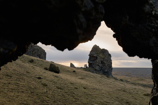 Looking through rock formation arch at dyrh&oacute;laey landscape