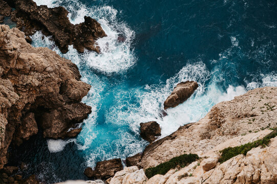 Turquoise surf and sea foam at Mirador del Puat, Mallorca, Spain