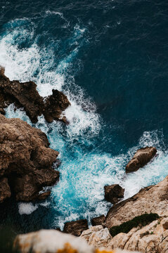Turquoise surf on rocky coast from Mirador del Puat, Mallorca, Spain