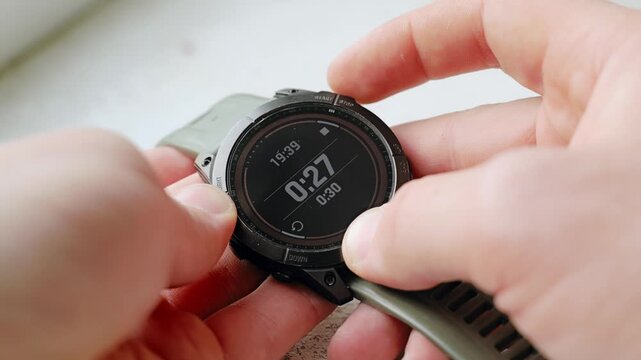 Man sets 30 second countdown timer on smartwatch in close detailed view