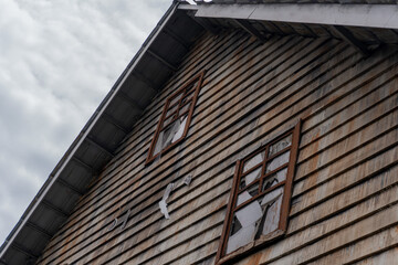 Haunted House Cracked Windows  Weathered Wood on Abandoned Farmhouse.