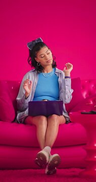 Studio, girl or laptop with neck pain on sofa for poor posture, elearning stress or discomfort. Mockup space, gen z student and tech with muscle tension on pink background for exam anxiety or massage