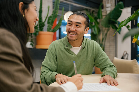 Friendly contract explanation and signing at office workplace