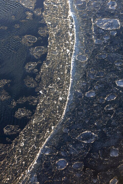 Ice floes on cold Elbe river in winter Germany aerial view
