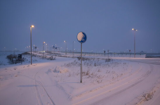 Night snowy cycling path in Rotterdam the Netherlands with strong winds