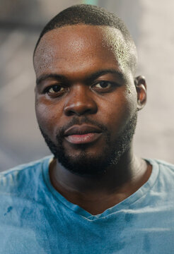 African man wearing light blue crew-neck T-shirt facing camera in studio showing neutral expression
