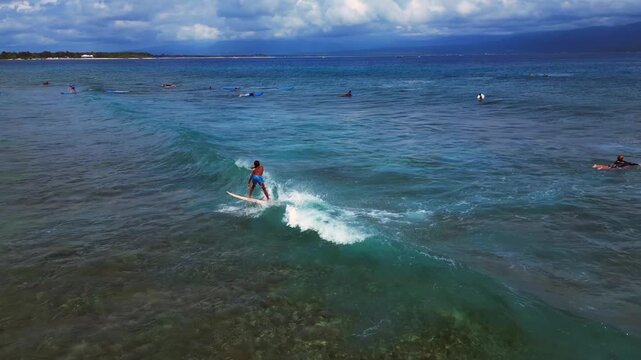 surfer surfing on waves, Gili Trawangan island. Magic aerial view drone