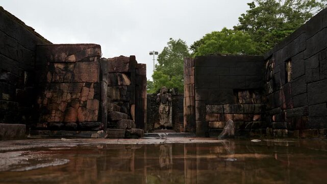 Ruins of sacred Hatadage relic house with Buddha statue and carved stone columns in Polonnaruwa, Sri Lanka