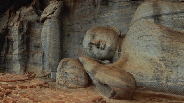 Reclining Buddha statue with stone carving, decorated pillow at Gal Vihara, Polonnaruwa. Sri Lanka