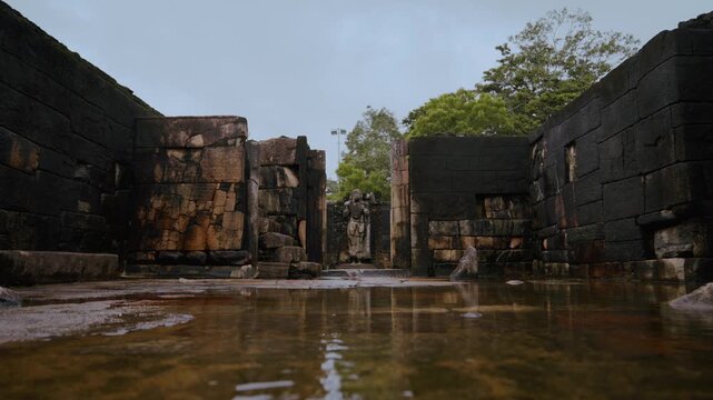 Buddha statue and brick walls of Hatadage tooth relic shrine, Polonnaruwa archaeological site, Sri Lanka