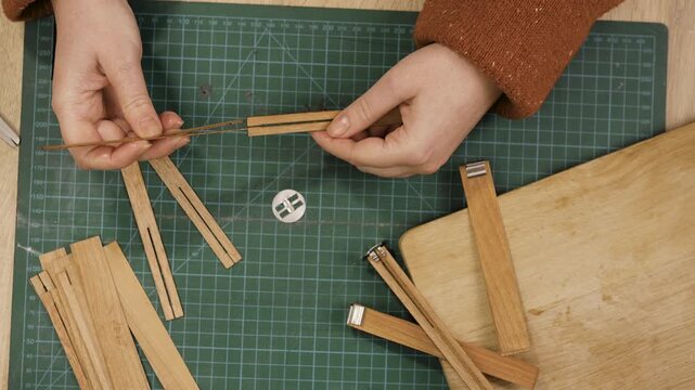 Creative hobby of homemade candle making. Woman using wooden wicks at home workshop. concept of making candles