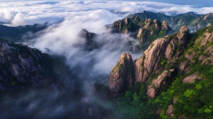 Obraz premium Misty granite peaks rising through clouds at sunrise