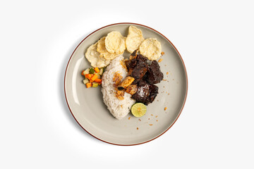 Indonesian grilled beef ribs with rice and emping isolated on white background top view. Nasi Iga Bakar.
