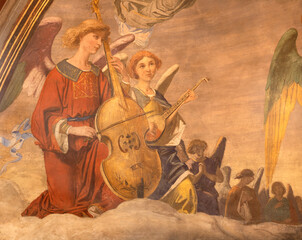 Fototapeta premium BUSTO ARSIZIO, ITALY - JANUARY 19, 2026: The fresco of angels with the music instruments in the church Santuario di Santa Maria di Piazza