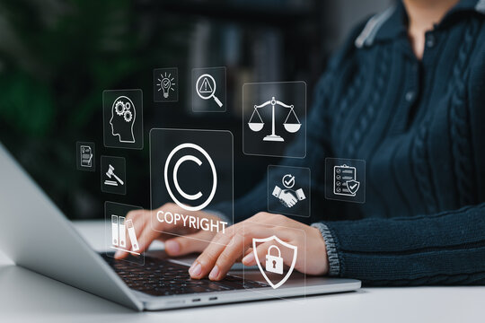 Copyright protection concept. Person using laptop with intellectual property icon representing legal compliance, content ownership rights, digital security, trademark law and creative asset protection