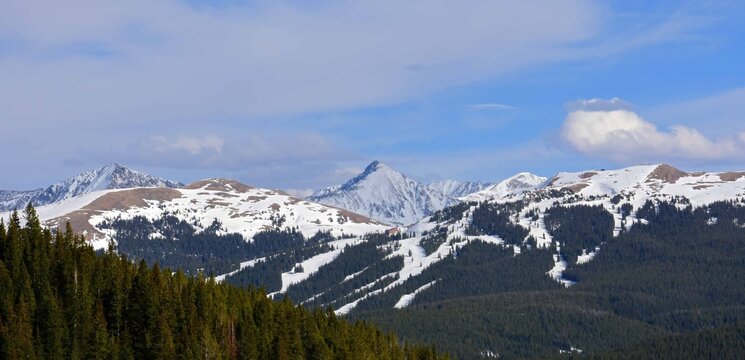 panoramic view of snow-capped mountains of the ten mile range of the colorado rockies and copper mountain ski area from  the top of vail pass, in colorado, in spring    