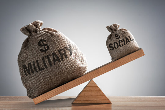 Concept of military spending increase, social assistance decline.