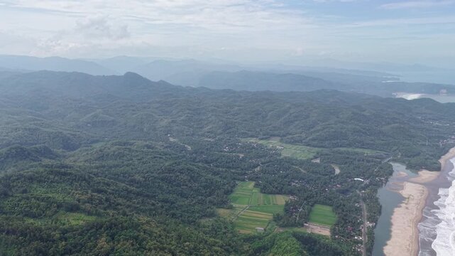 Aerial View of Lush Forested Hills, Rice Fields and Villages in Pacitan, Indonesia Mountain Landscape