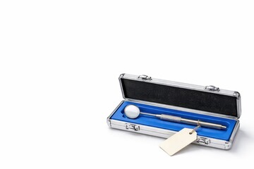 Dental mirror tool stored in open aluminum instrument case with molded silicone insert and blank inventory hang tag