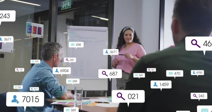 Presenter pointing chart causing metric bubbles filling room and over team, showing business data