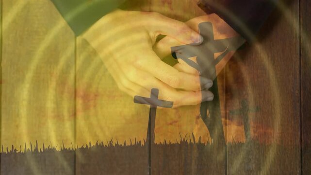 Overlay fading in, hands holding and rotating small cross, ripples radiating, evoking memorial mood
