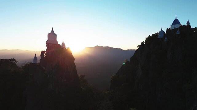 Fly over mountain gap at Buddhist temple in Thailand