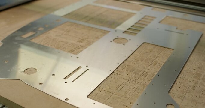 High angle view of laser cut metal sheet part on workbench