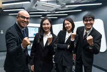 Fototapeta premium Happy diverse Asian business team analyzing financial statistics in office.