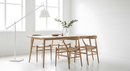A minimalist Scandinavian dining set featuring a light oak table with slender, tapered legs and four matching chairs with woven paper cord seats.