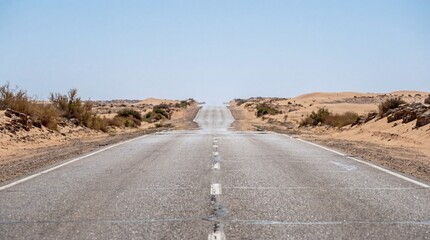 Desert road shimmering under intense heat, disappearing into the horizon