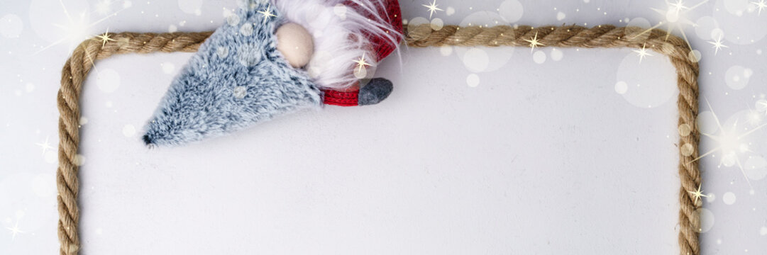 Horizontal festive Christmas banner with gnome, rope and golden decor