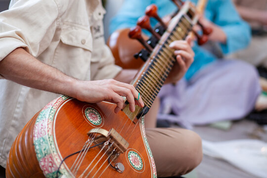 a man plays the sitar at a concert
