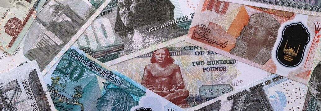 Egyptian pound money bills pile on table. Egypt banknotes of EGP currency close up.